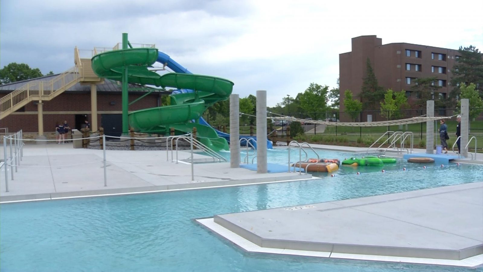 swimming pool with waterslides in the background