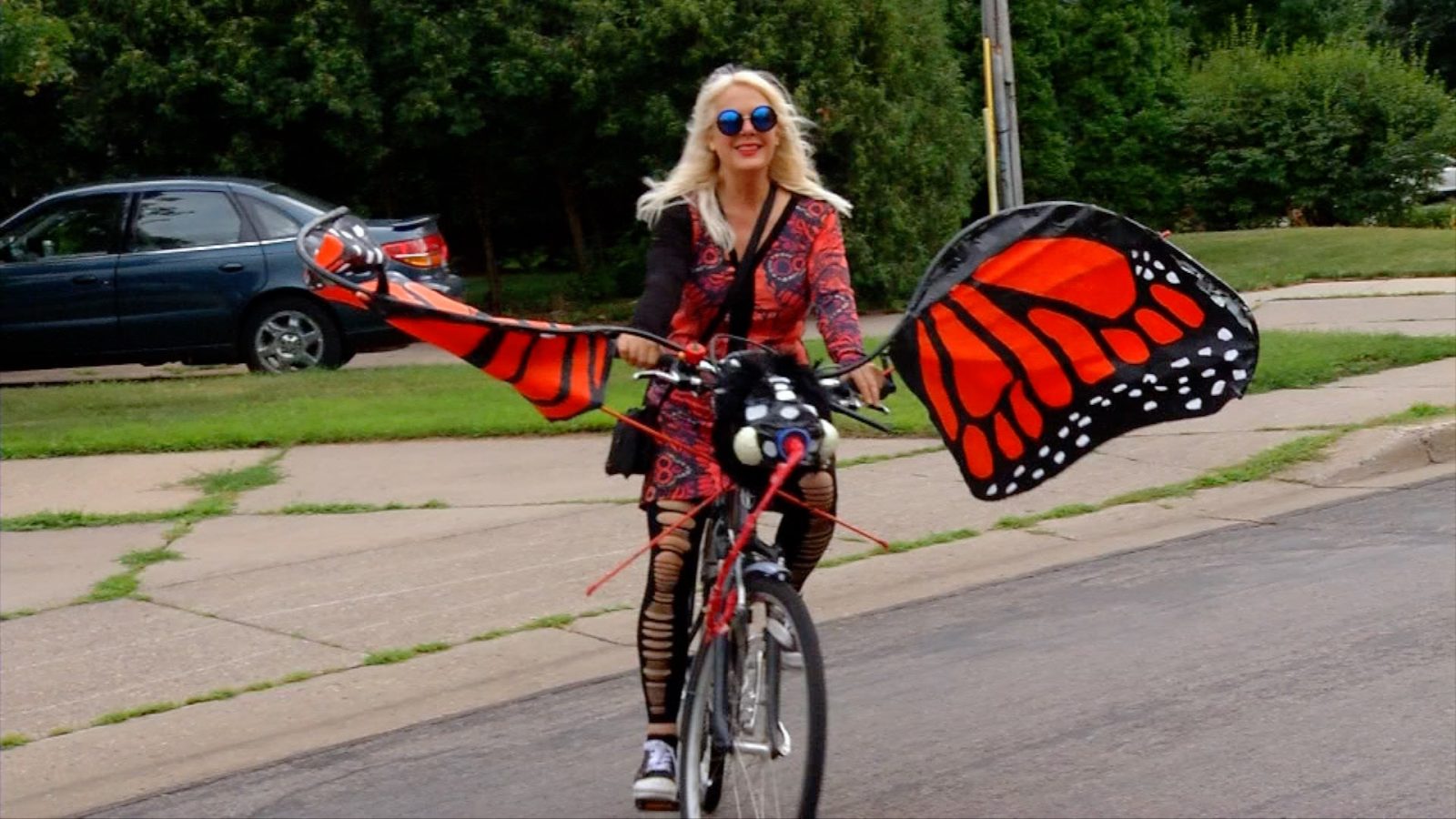 bike rider in butterfly costume at Robbinsdale Pet & Wheel Parade