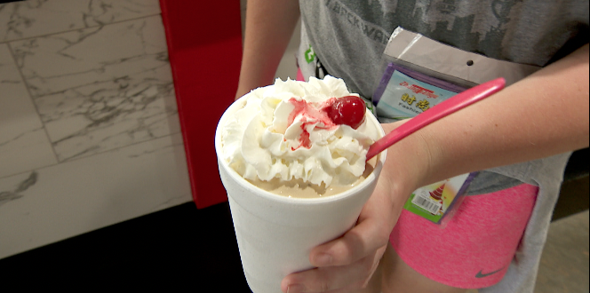 a malt with whipped cream and a cherry on top