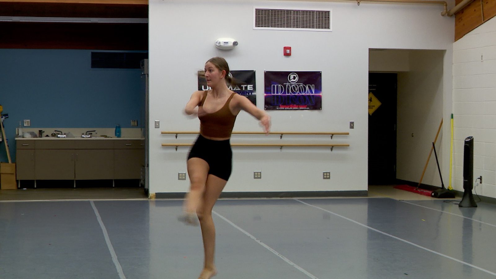 A young woman practices a solo dance routine in a studio in New Hope