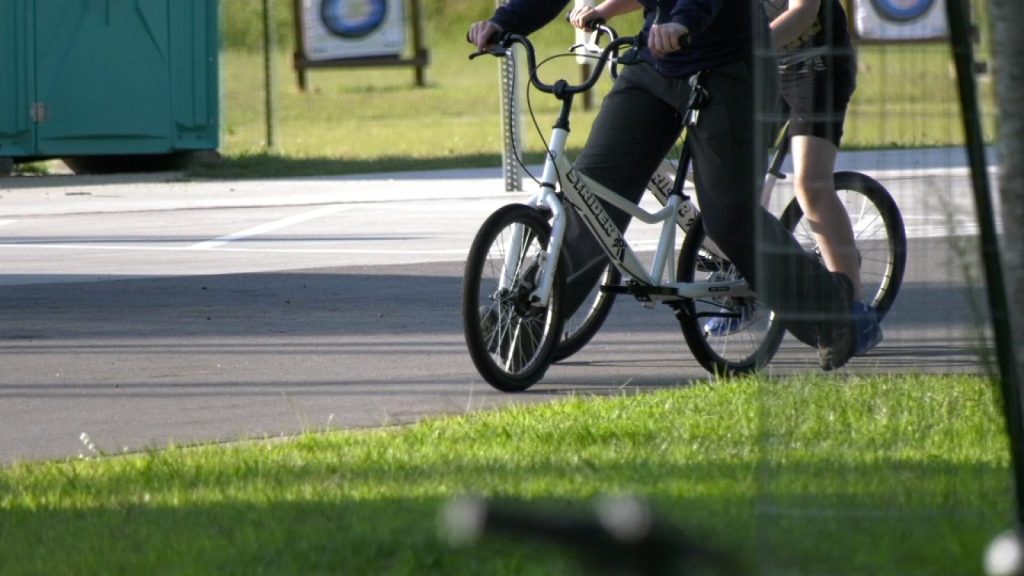 Two white mid-size Strider bikes 