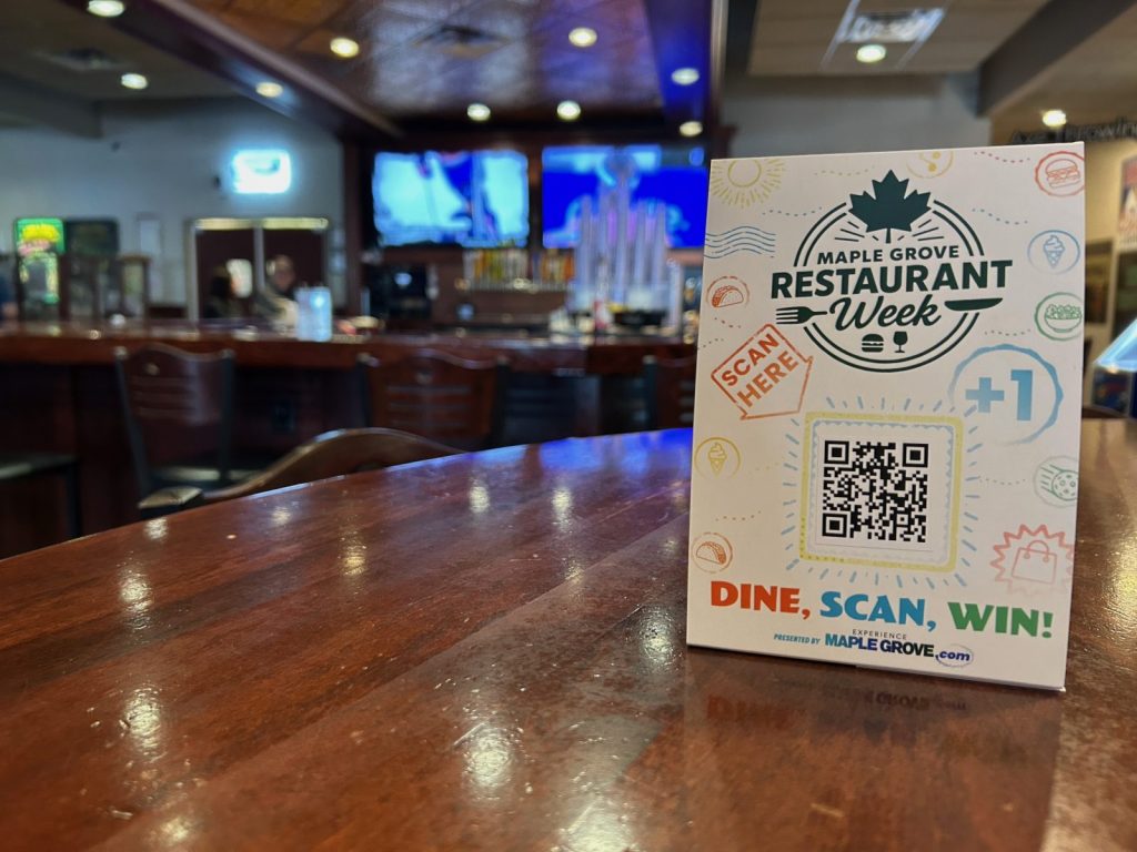 Maple Grove Restaurant Week advertisement sitting on a table.