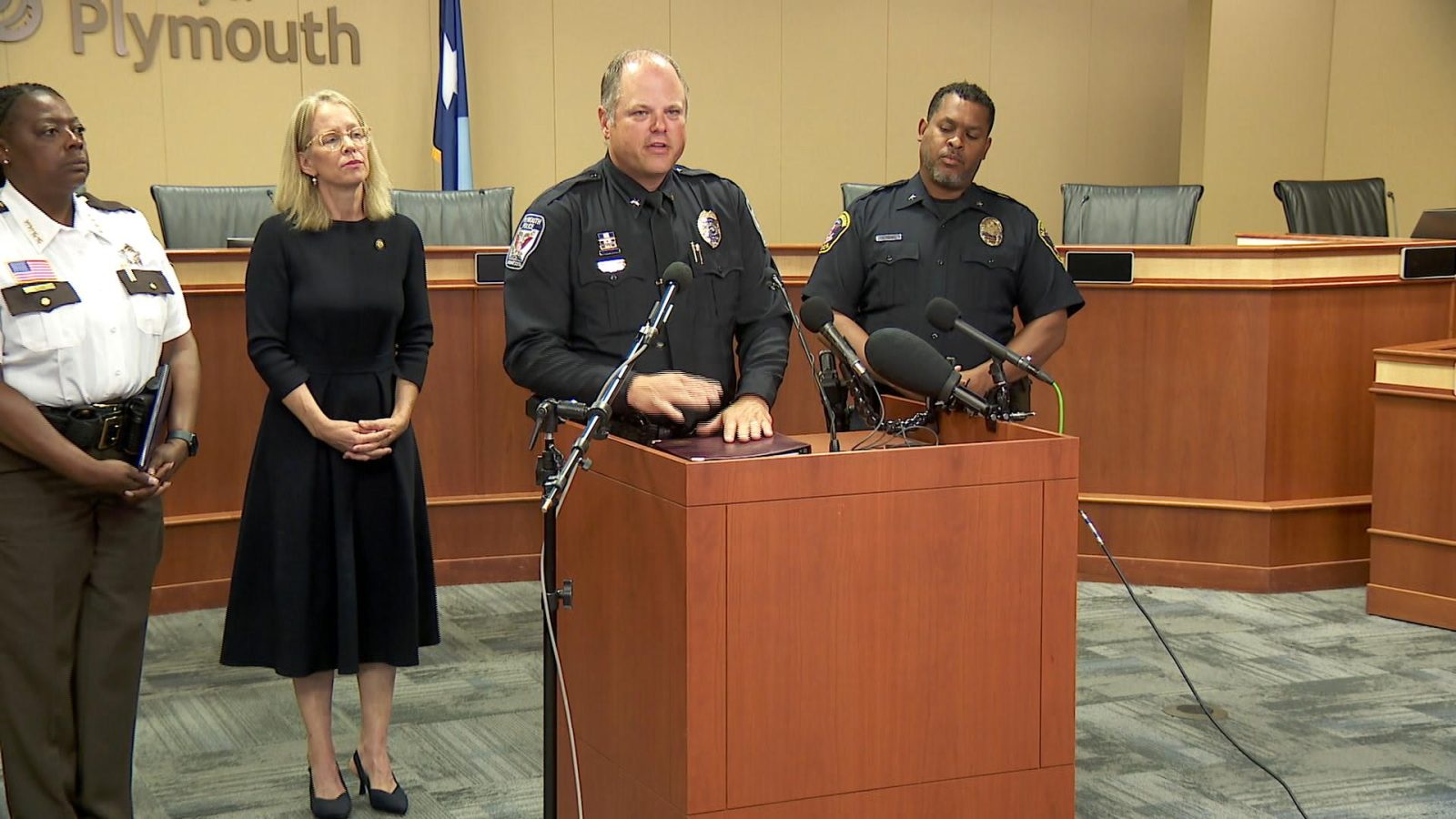 plymouth police chief erik fadden speaks at a podium