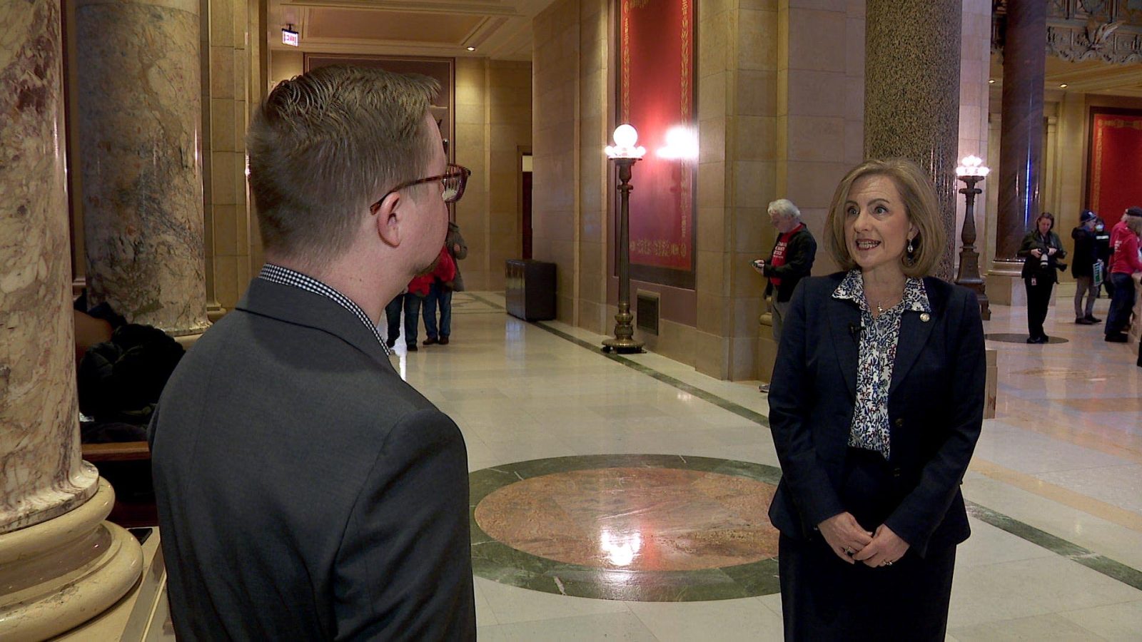 kristin robbins stands in the capitol