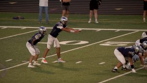 Champlin Park quarterback Miles Felton awaits a snap in game versus STMA
