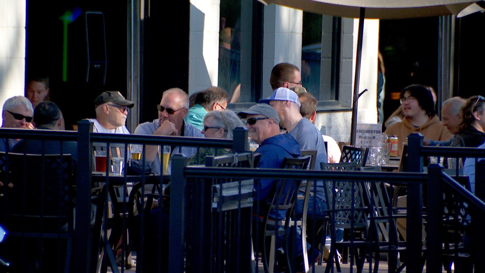Scene of people eating and drinking outside on a restaurant patio