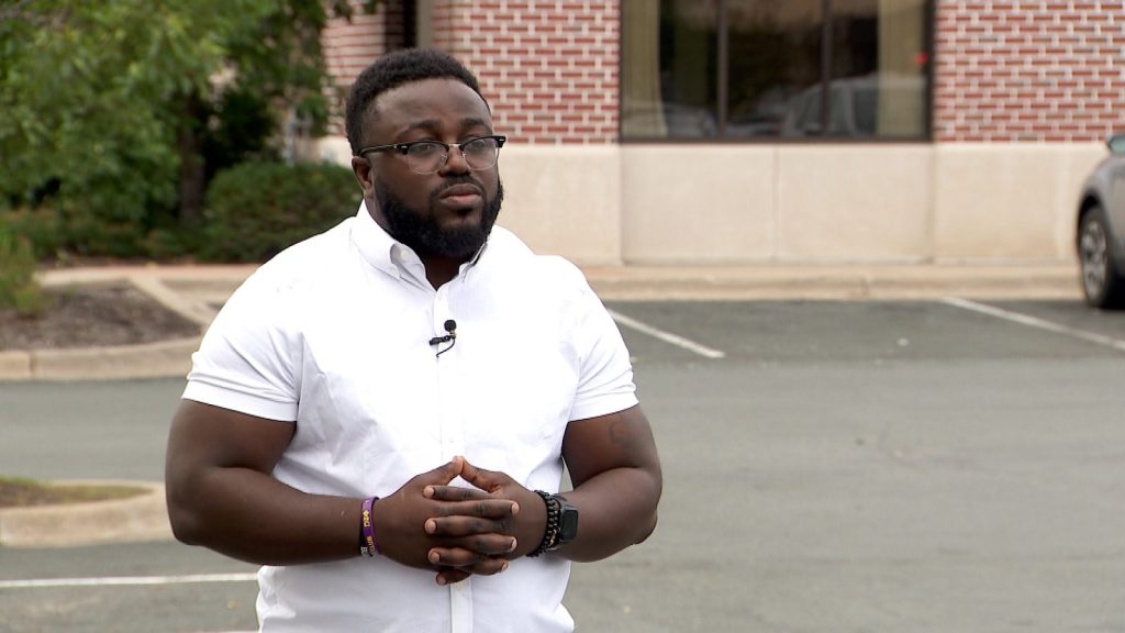 Man in a white button-up and glasses
