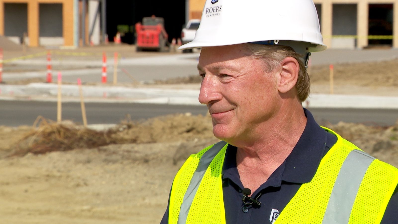 man wearing a hard hat outdoors at a construction site