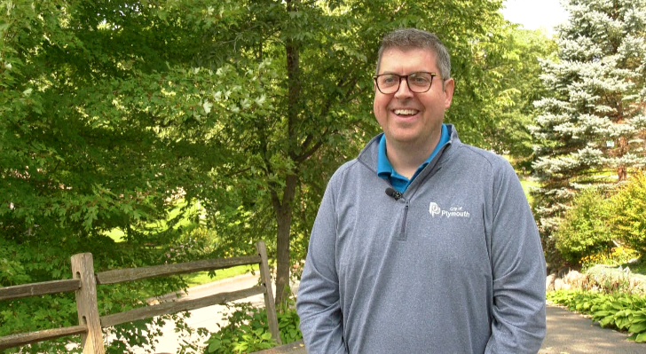 Clark Gregor wearing a sweater with trees in the background