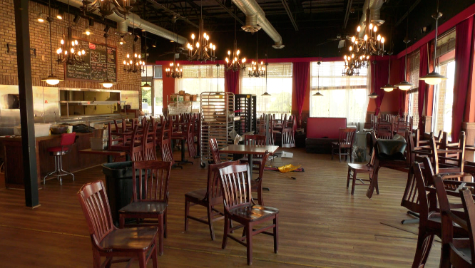 tables and chairs strewn about in an empty restaurant