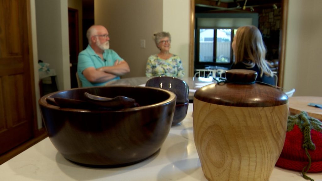 handmade bowls and jars with a couple in the background