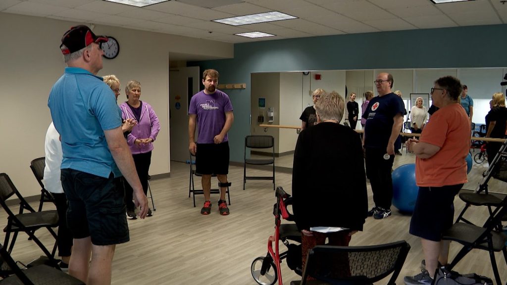 people stand in a circle in front of chairs
