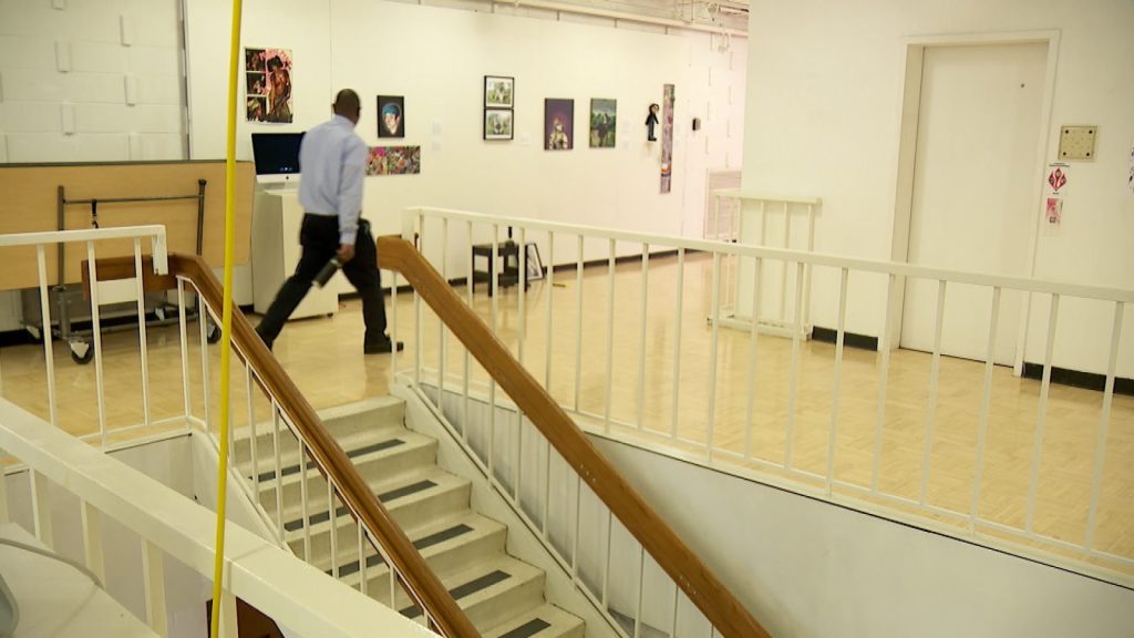 someone walks through art gallery