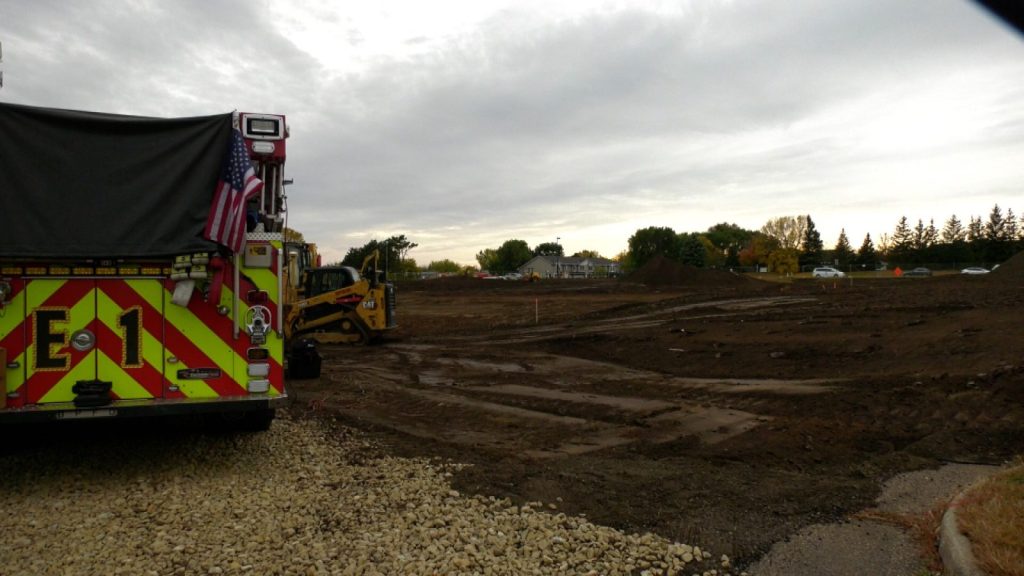 plot of land with a firetruck next to it