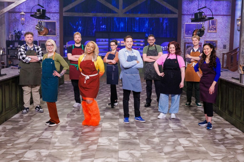 halloween baking championship contestants standing on a set