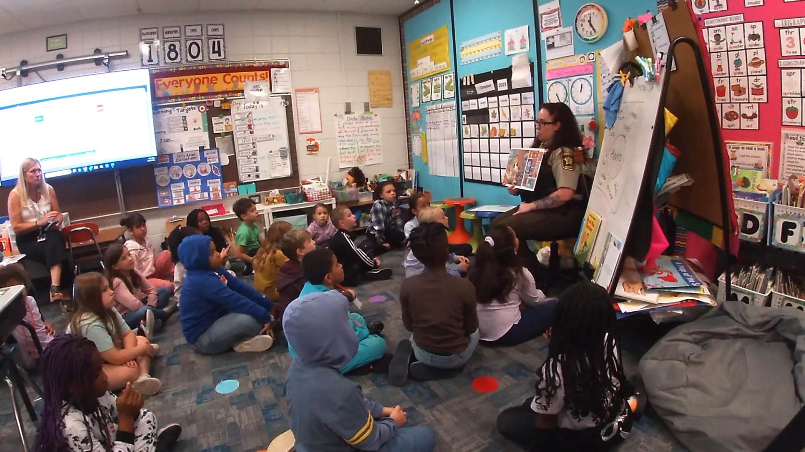 a police officer speaks to a classroom