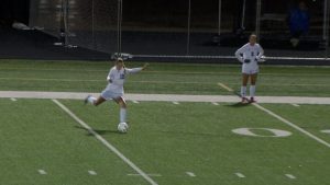Heritage Christian Academy girls soccer player kicking soccer ball