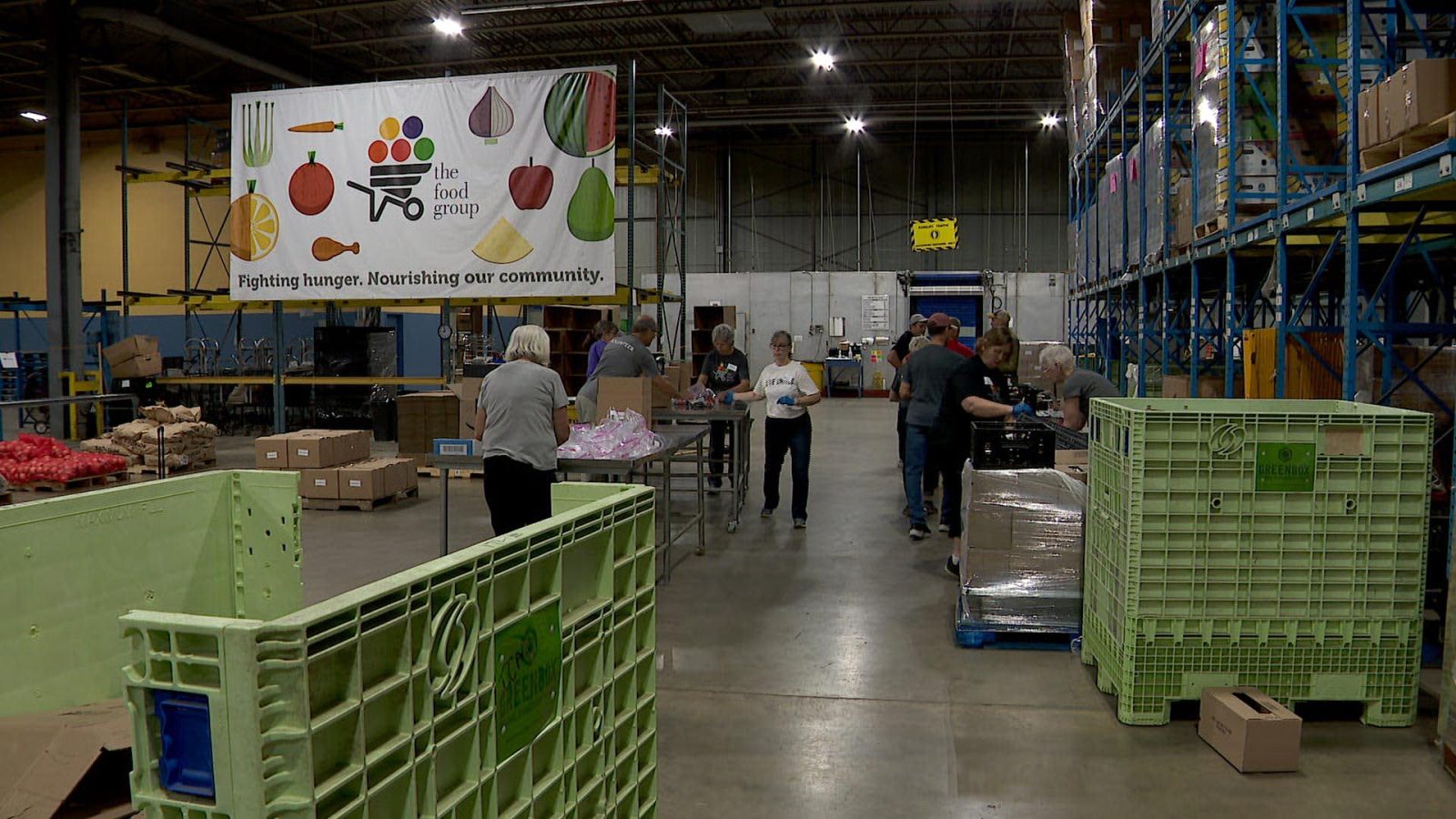 volunteers load groceries
