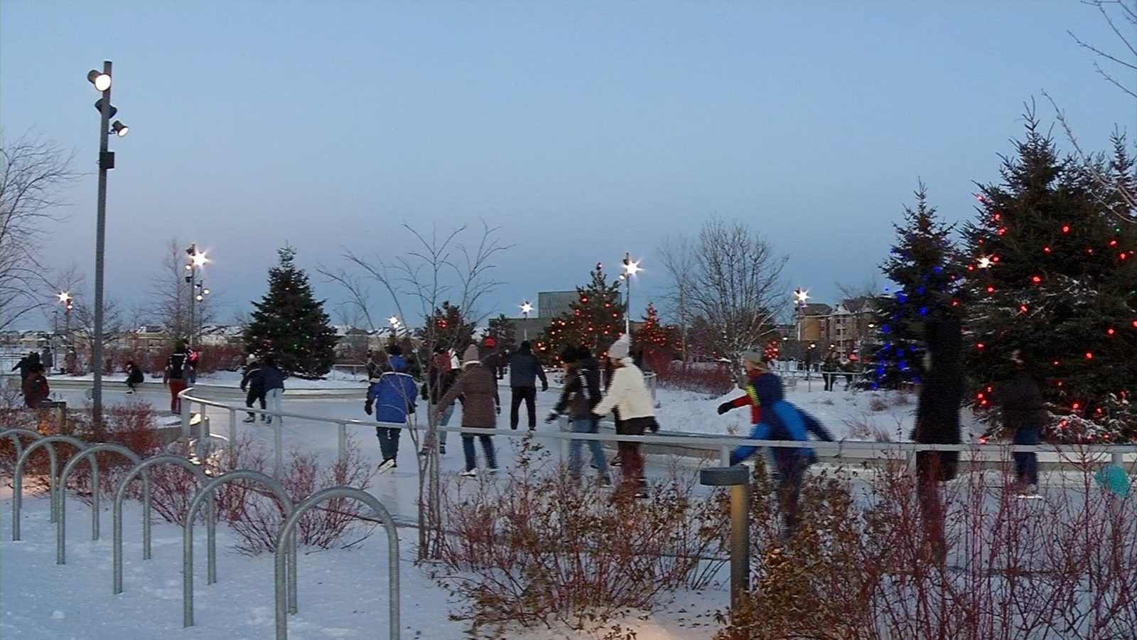 ice skaters on an outdoor skating loop in the winter