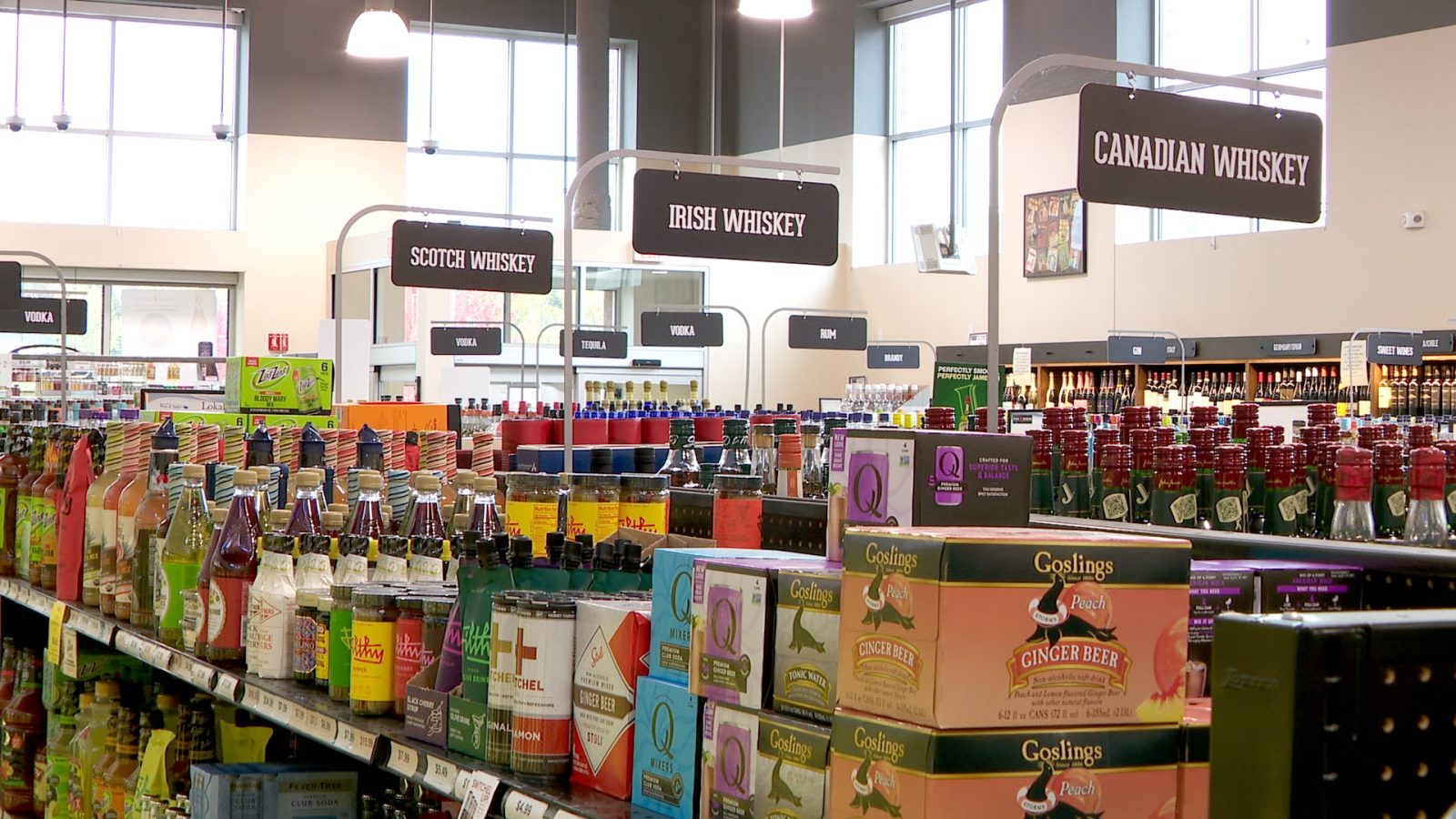 signs and liquor bottles on shelves inside a store