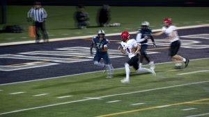 Eden Prairie quarterback Jackson Baakum scores in the first half of the Eagles 21-16 win over Champlin Park football in the Class 6A playoffs on October 31, 2025