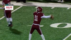 Kaden Harney of Maple Grove football gets set to throw a pass in the Crimson playoff game against Lakeville South