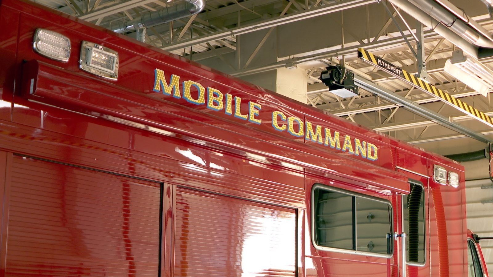 Top of new emergency response vehicle in the garage bay of a fire station.