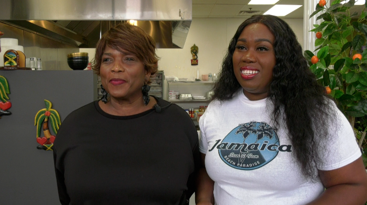 two women standing in a restaurant