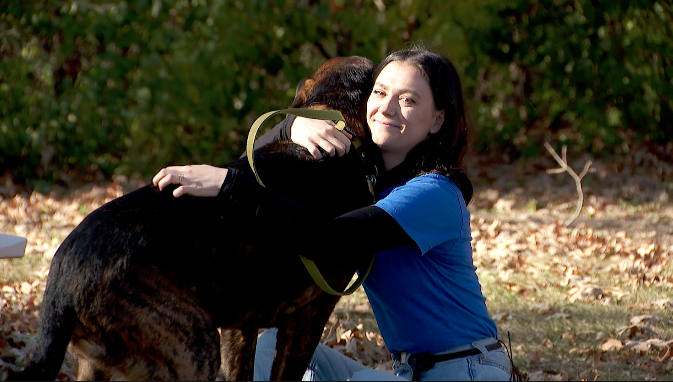 woman hugging a dog