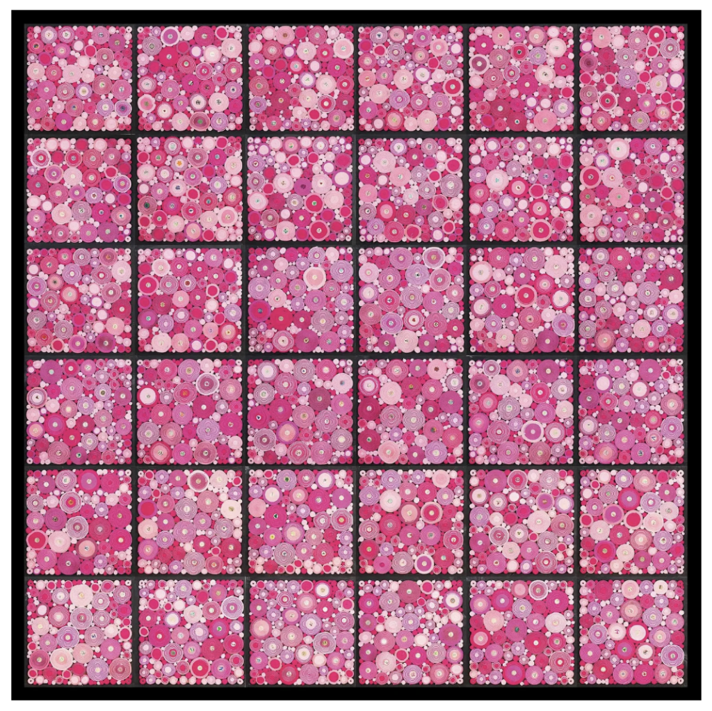 a board full of pink-toned scrolls, rolled and split into boxes