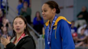 Wayzata state champion diver Ashley Mouyenga receives her first place medal