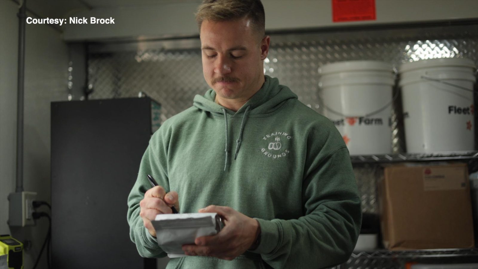 man labels a bag with a marker