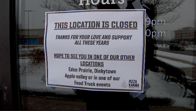 sign on a door announcing the closure of pizza karma