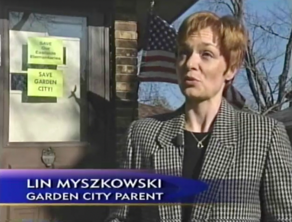 Lin Myszkowski standing in front of a house