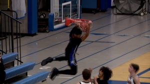 Kyree Nelson dunks for Hopkins boys basketball in the Royals' 81-68 loss to St. Louis Park