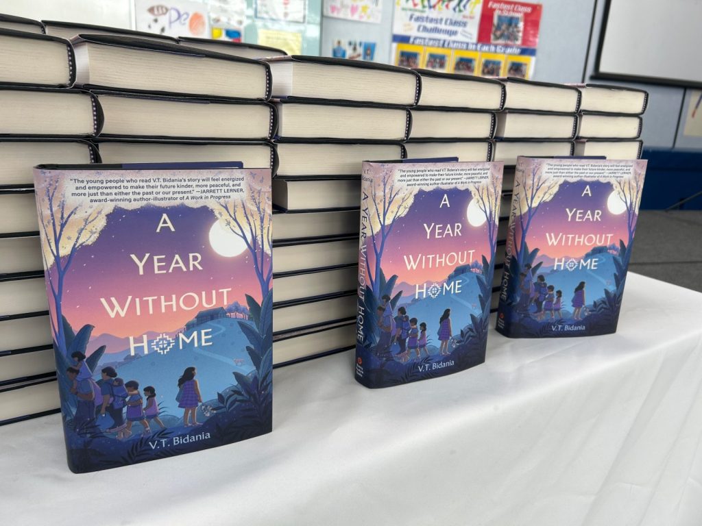 The book "A Year Without Home" by Author V.T. Bidania, laid out on a table.
