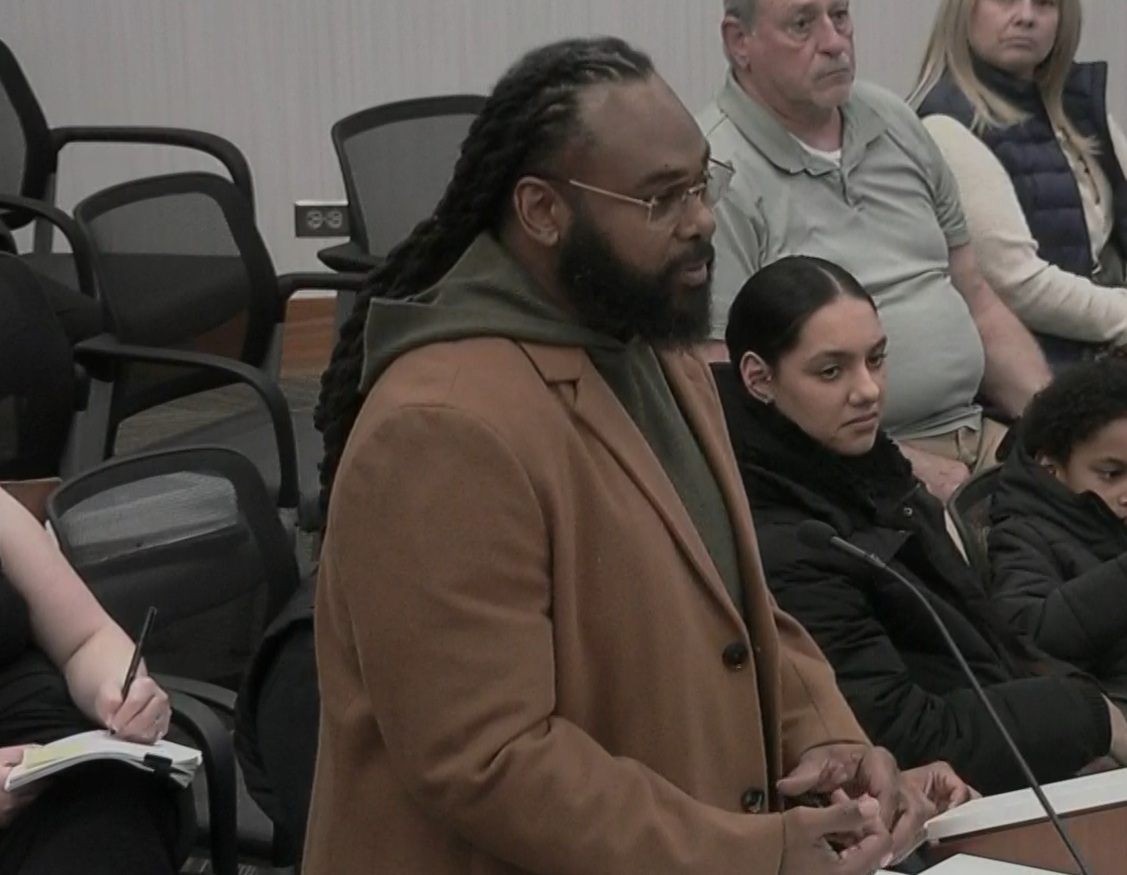 man talks at a podium