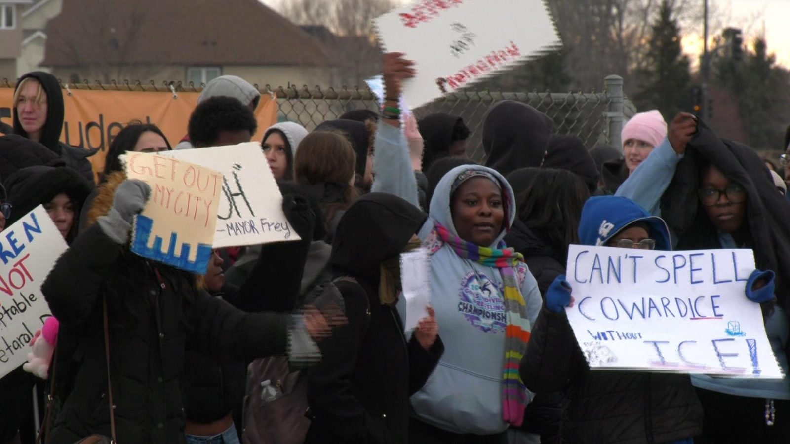 students hold signs at a protest 