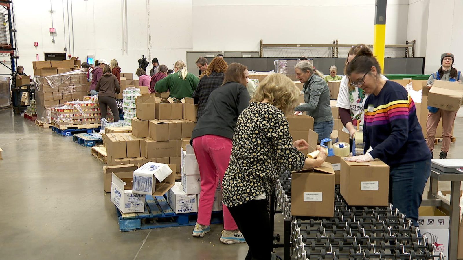 Volunteers pack boxes with food at Second Harvest Heartland in Brooklyn Park.