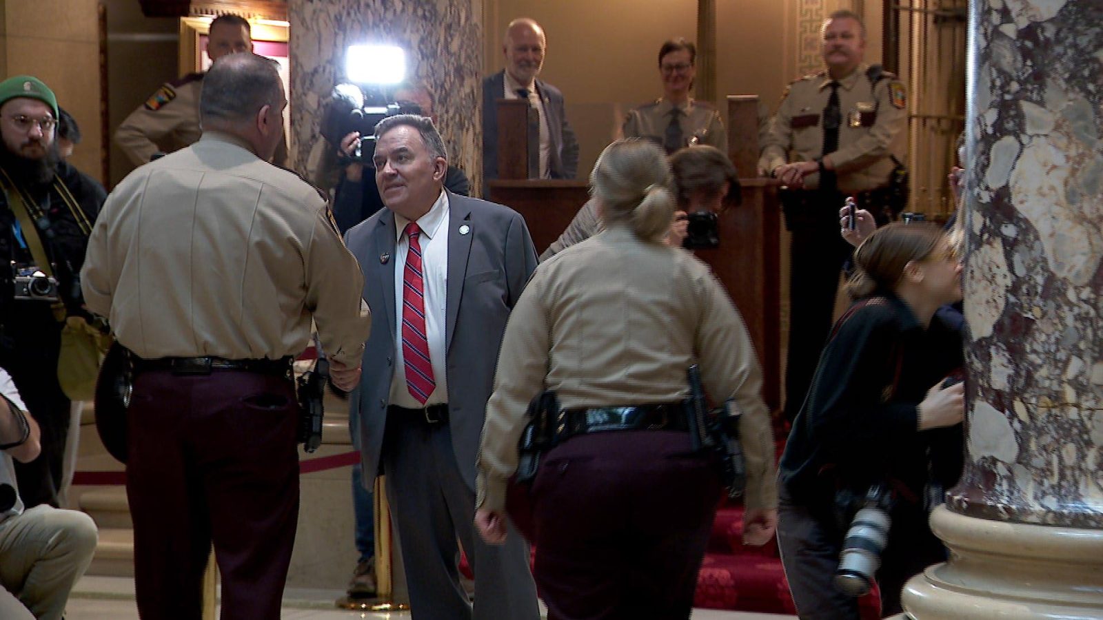 Sen. John Hoffman shakes hands with a Minnesota State Trooper outside Senate chambers.