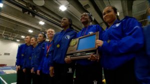 Hopkins girls gymnastics and their Section 6AA team championship trophy