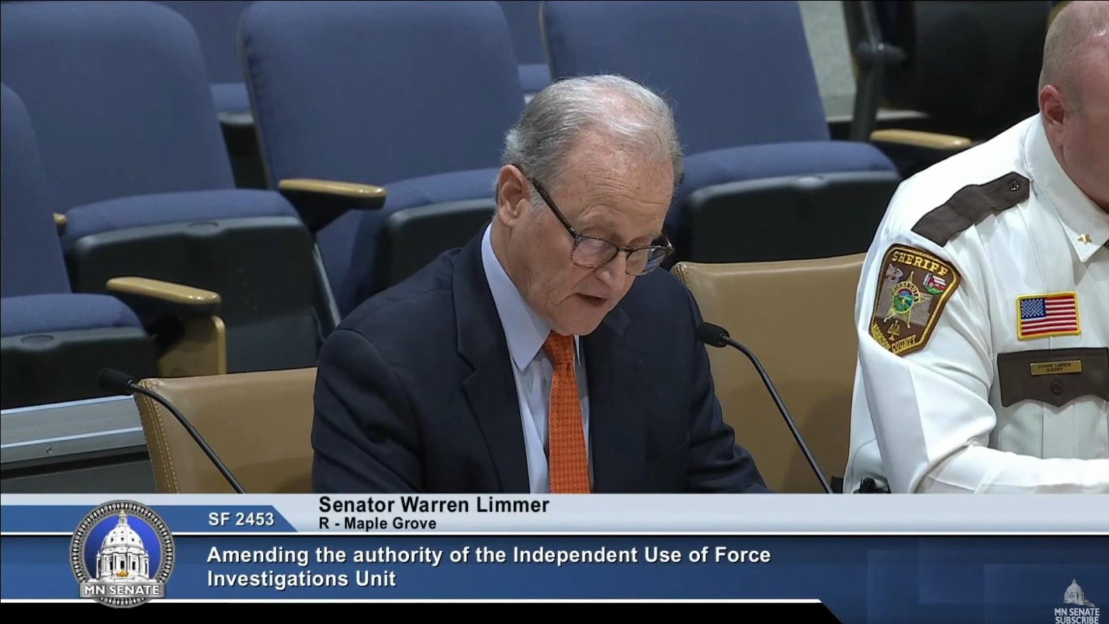 senator warren limmer speaking at podium