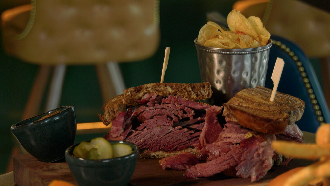 pastrami sandwich with chips and pickles from kitchen and rail in golden valley