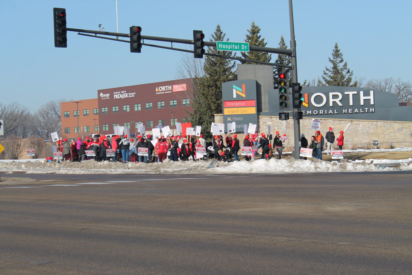 picketers stand a street corner