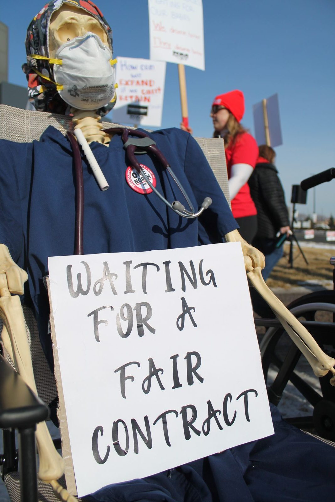 a skeleton dresses as a nurse sits in a chair