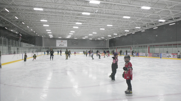 people skating inside the maple grove community center trustone rink