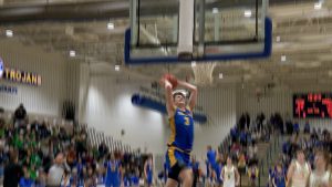 Nolen Anderson goes in for a dunk versus Edina in the Trojans section tournament win