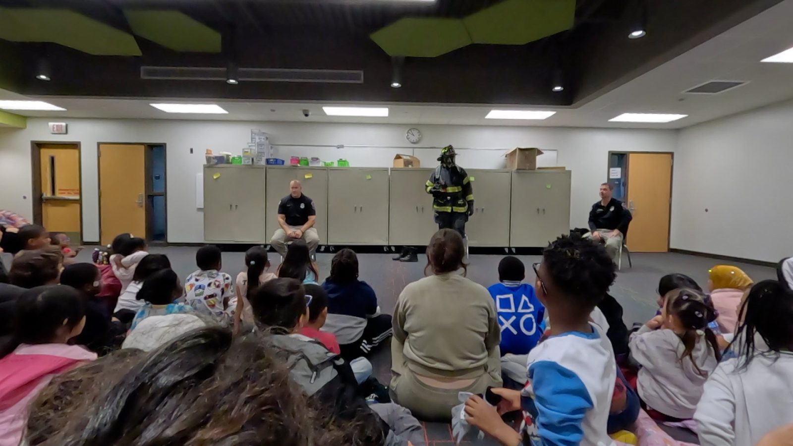 firefighters talking to kindergarten students