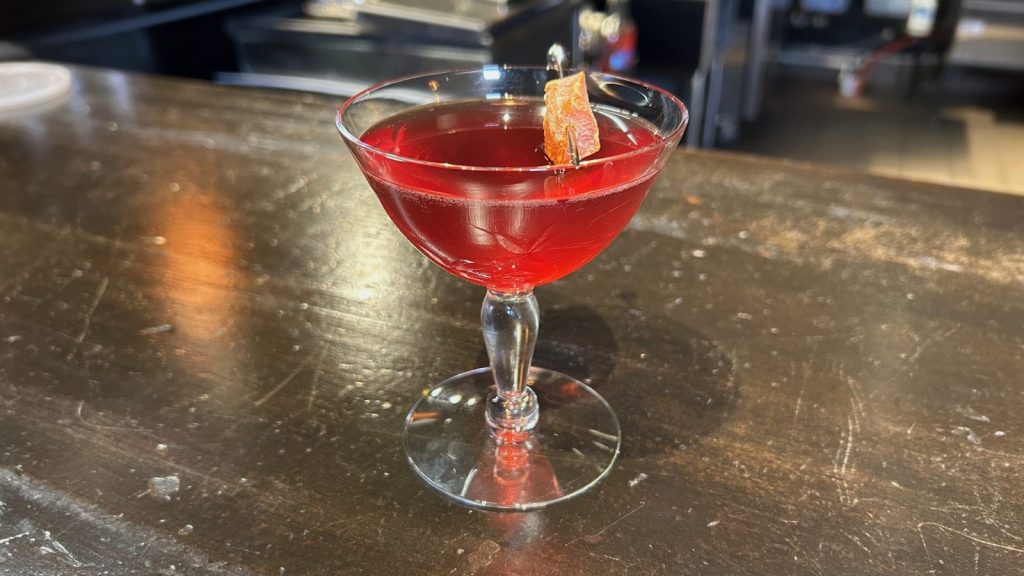 red cocktail sitting on a bar at skaalvenn distillery in brooklyn park