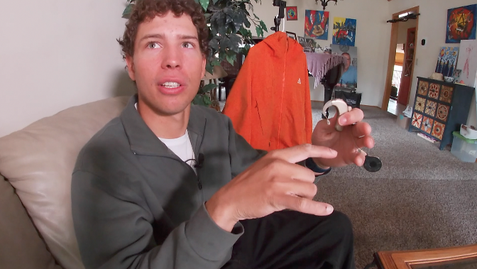 kole krier shows off his cochlear implant device